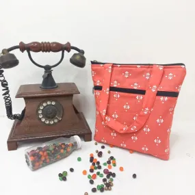 Small Handbag Orange Colour with White Flower Design.